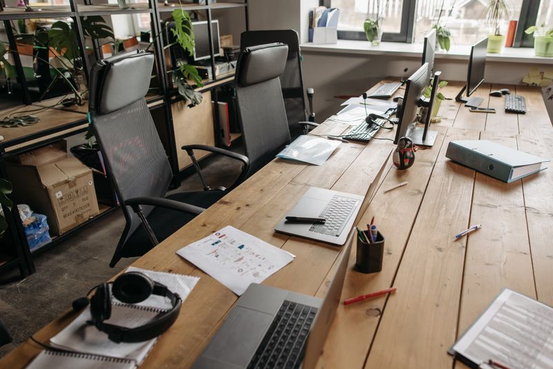 Professional co-working office space with clean desks and modern setup