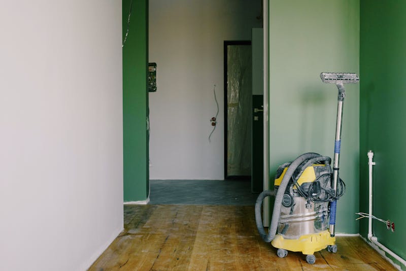 Industrial cleaning equipment removing construction debris from renovation site